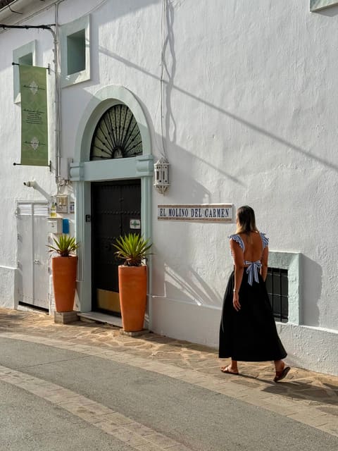 Liza walking in through the entrance of Molino del Carmen in Gaucín, Andalucia
